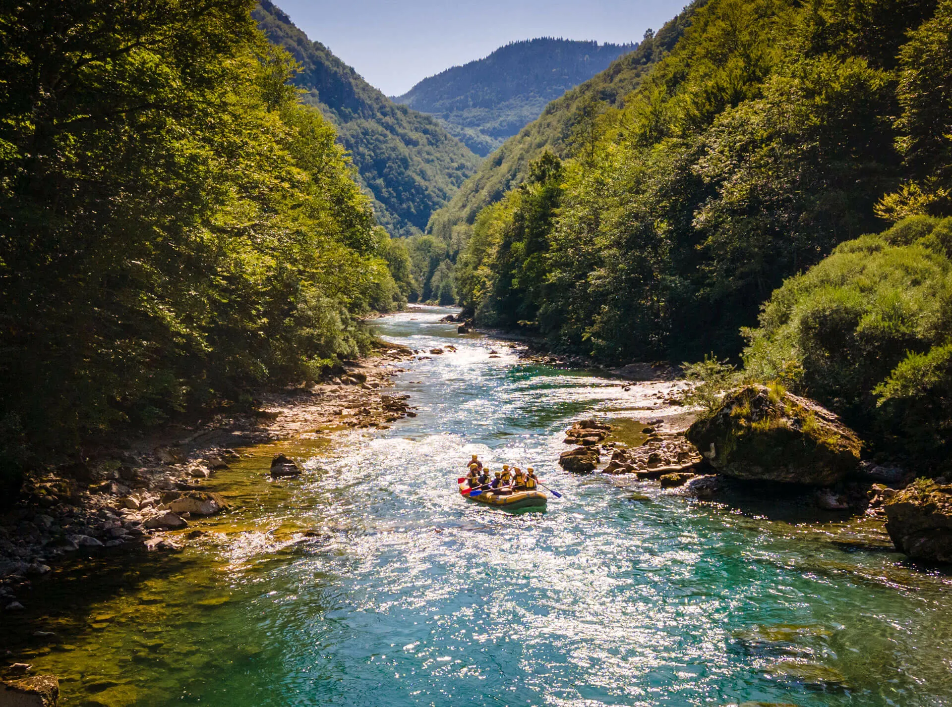 Rafting on the clear Tara River between forested mountains